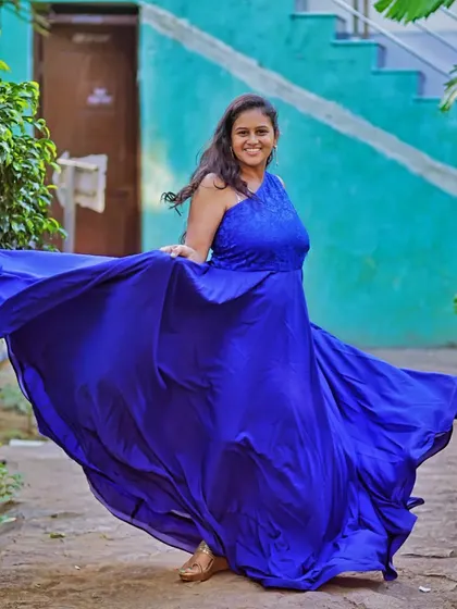 The one-shoulder style of this blue infinity gown is both comfortable and chic, perfect for showing off your baby bump.