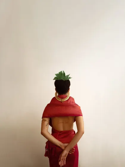 A minimalist and artistic back portrait. This shot focuses on form, color, and the subtle details of the styling, creating a quiet yet powerful image.