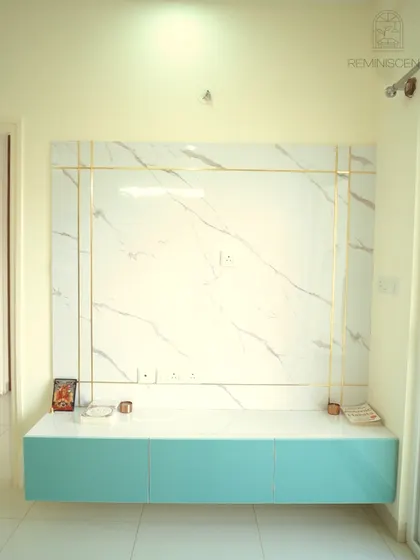A full view of the aqua-blue and marble TV unit, showcasing its sleek design and elegant gold accents. The floating design makes the space feel larger and more open.