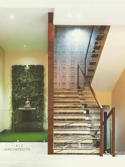 We bring nature indoors to create moments of peace and beauty. This vertical garden, installed as a feature wall by the staircase, acts as a living piece of art, improving air quality and adding a vibrant, natural texture to the home's interior design.