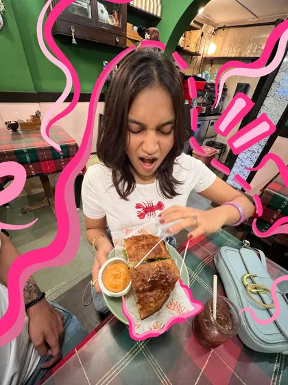The face you make when the food is just that good. The chaotic pink doodles perfectly capture the feeling of diving into a delicious sandwich.