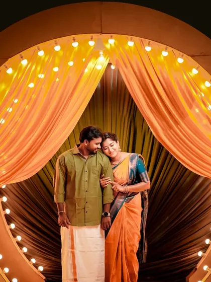 A beautifully lit indoor pre-wedding portrait in Bangalore, using curtains and lights to create a warm and inviting stage.
