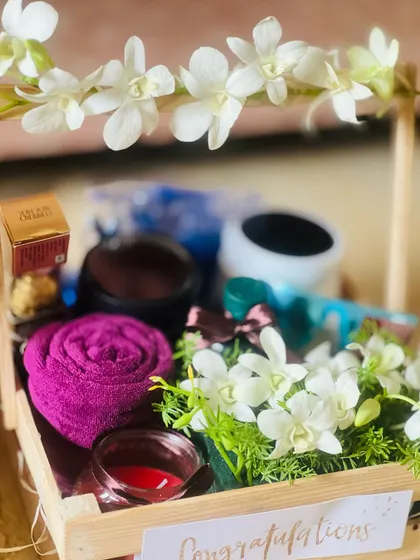 Another close-up, showing the arrangement of a rolled towel, candle, and other items within the crate.