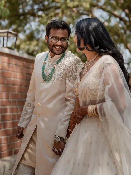 A stunning bride in a white lehenga, exuding grace and elegance. We use creative framing and lighting to capture a variety of beautiful portraits.