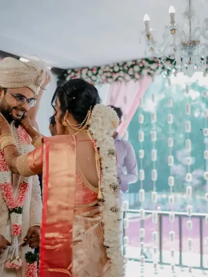 A happy moment during the wedding ceremony with a beautiful Ganesha floral arrangement in the background.