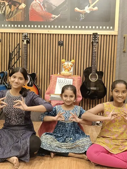 Our young students celebrating Saraswati Pooja at the academy. We believe in nurturing a deep cultural understanding alongside artistic training, creating a holistic learning experience.