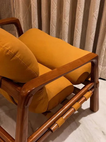 A side view of the "Marshmallow" Armchair, detailing the way the cylindrical cushions are cradled by the Ashwood frame. It’s a design that prioritizes both aesthetics and comfort.