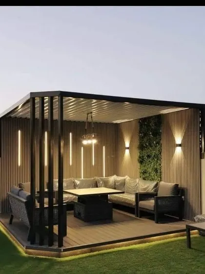 A covered rooftop seating area with comfortable sofas and chairs. The design uses a mix of materials like wood, metal, and greenery to create a stylish and protected outdoor room.