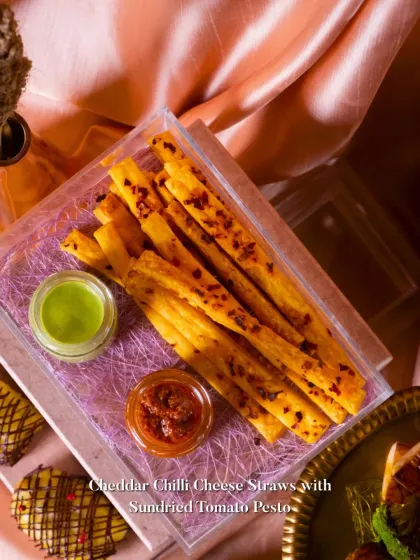 Cheddar Chilli Cheese Straws served with a sundried tomato pesto. A classic savory snack, elevated with a flavorful dip.