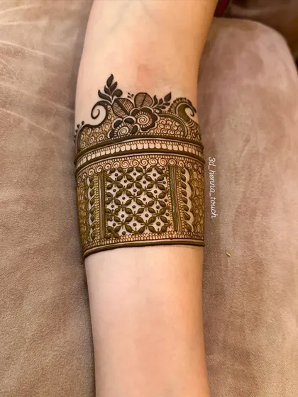 The arm band design in its early stages, with the main cuff pattern completed. This shows the clean and precise foundation of our work.