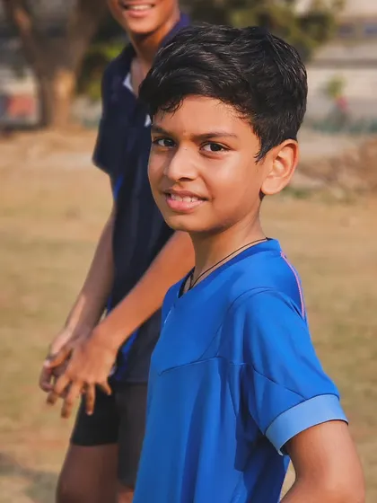 A young player smiles during a break at our summer camp, showing that hard work can also be fun.
