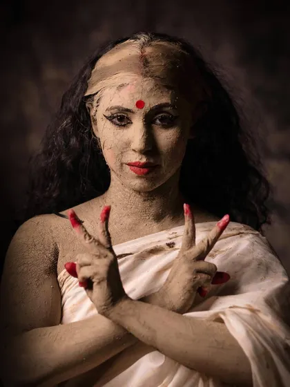 The final stage is coloring, where the spirit of the goddess enters the idol. This image shows the 'Sandhi' or moment of transformation, where the figure becomes divine.
