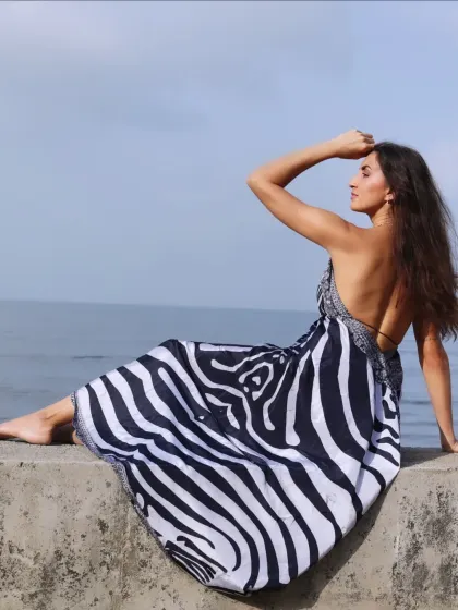 A contemplative pose looking out at the sea. This type of shot is great for creating a narrative and evoking a sense of wonder or longing.