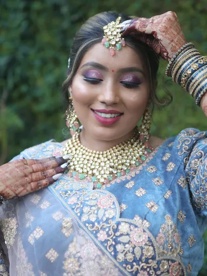 A close-up shot showcasing the beautiful eye makeup and perfectly placed maang tikka. My students learn to master these details.