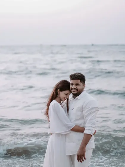 A comfortable embrace by the ocean. This pose shows a deep sense of peace and contentment with each other.