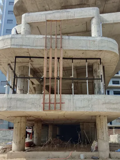 The Jenga-inspired building during construction. This shot shows the raw concrete structure and the beginnings of the facade installation, revealing the complex interplay of the stacked volumes.