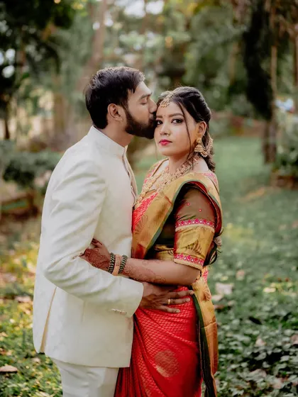 A loving embrace with a forehead kiss. This pose is timeless for a reason; it conveys protection, affection, and intimacy all in one frame.