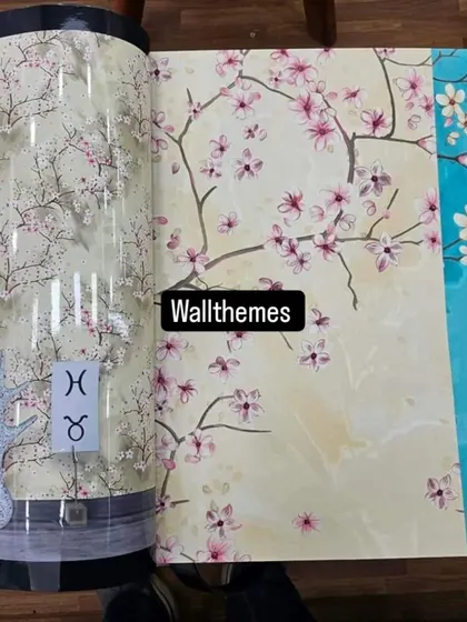 Samples of different color variations of a cherry blossom wallpaper laid out for comparison.