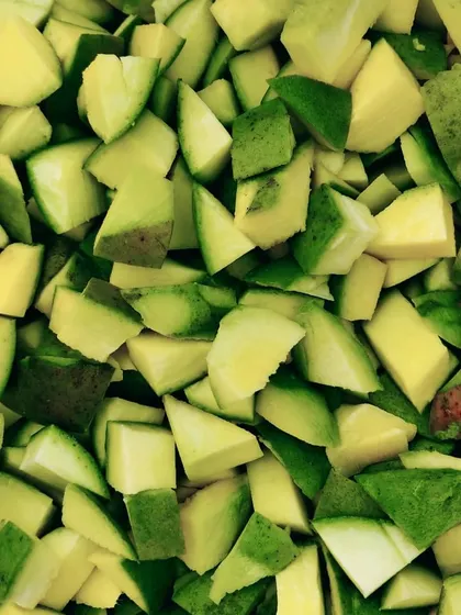 The process of chopping raw mangoes for my pickles. I ensure they are the perfect size for a good bite.