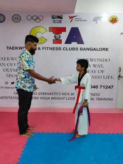A handshake for a new red belt.