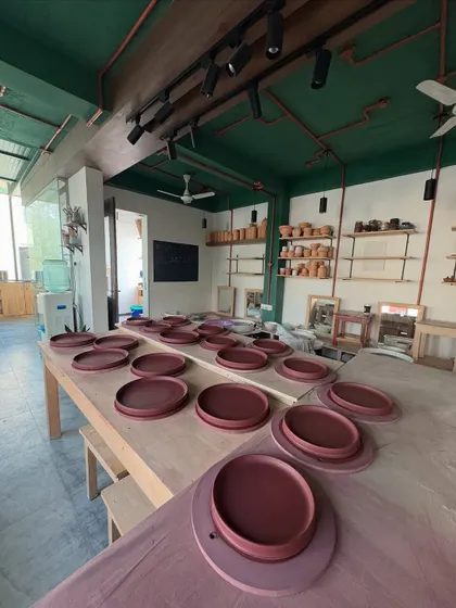 The studio table filled with dinner plates from the Lagavi collection. Seeing hundreds of uniform pieces ready to go is both daunting and incredibly satisfying.