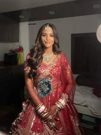 Ranchi looking confident and beautiful. The soft waves in her hair and the glowing makeup create a modern yet traditional bridal look.