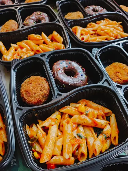 These party boxes feature our homemade red sauce pasta, a veg cutlet, and a choco donut. We pack each meal with care to ensure it's a delightful experience for your guests.