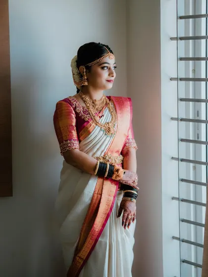 Just being a 'Madumagalu' (bride). This bride is glowing in her traditional white and red saree, with makeup that enhances her natural beauty.