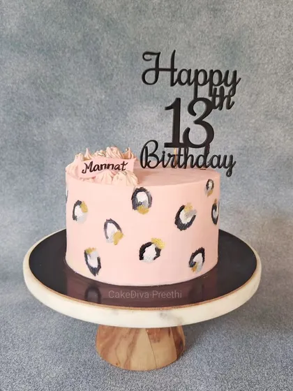 This chic cake for a 13th birthday features a hand-painted leopard print design on a baby pink frosting. It's a stylish way to celebrate becoming a teenager.