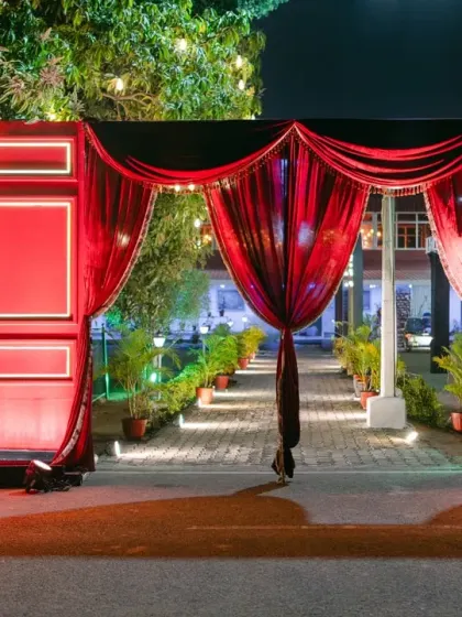 Inspired by the glamour of Broadway, we designed this grand Sangeet entrance with red velvet drapes and sparkling marquee lights, setting a theatrical and exciting tone for the evening's festivities.