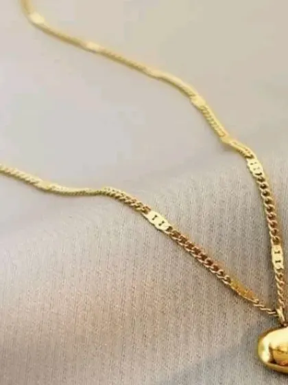 A simple gold-toned necklace with a puffy heart pendant engraved with the word "love." A sweet and affordable piece at just 10 shekels.