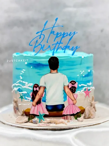 A heartwarming cake for a father who shares his birthday with his two twin daughters. The hand-painted design captures a beautiful family moment on the beach.