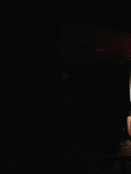 A solitary bridal portrait under a dramatic red light. The minimalist composition and use of color create a powerful, moody, and unforgettable image.