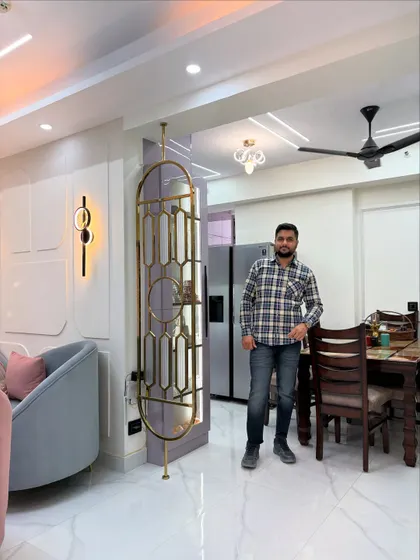 Here I am in a recently completed living and dining space. You can see the elegant metal partition that separates the areas without blocking light, and the cohesive design that flows from the seating area to the dining table.