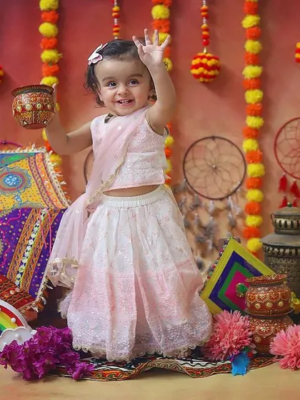 We can also celebrate festivals! This little girl looks so adorable in her traditional outfit for a special Eid-themed photoshoot.