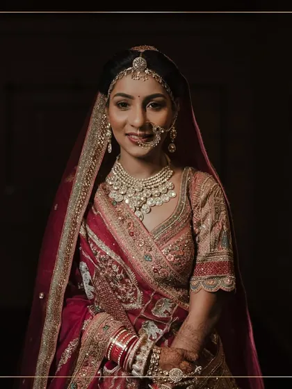 A classic bridal portrait. The bride's soft makeup, traditional nath, and beautiful lehenga create a look of timeless North Indian elegance.