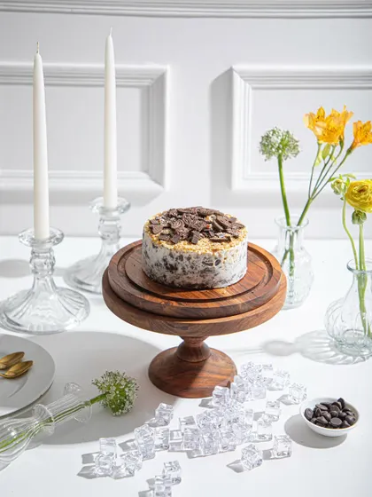 A wider shot of the Cookies and Cream ice cream cake, showing its place as the centrepiece of a beautiful dessert table.