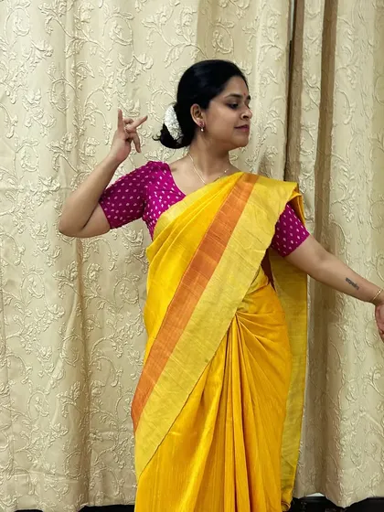 A graceful standing pose in my yellow saree for the first day of Navratri. The color, pose, and expression all come together to honor the specific attributes of the goddess Shailaputri.