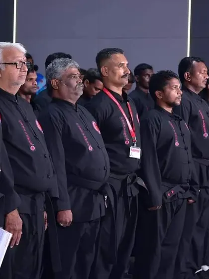 A line of masters and instructors, including myself, standing in observance at a formal event. This shows our solidarity and respect for the traditions of martial arts.