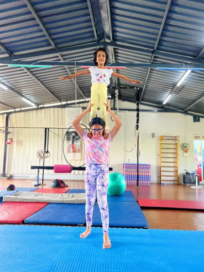 Another amazing duo showing off their balance and teamwork. We teach students how to safely support each other in our partner acro classes.