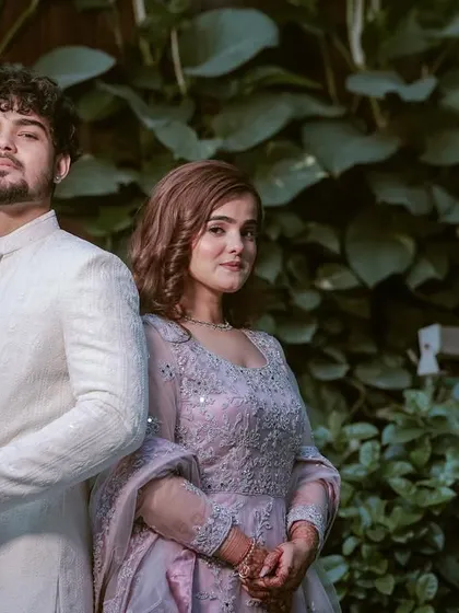 A stylish, back-to-back pose against a lush green backdrop. We love getting creative with our couple portraits to match their vibe.
