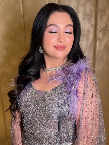 A close-up of Ishita's cocktail glam. The lavender shimmer on her eyes and the glossy lip create a look that is both trendy and incredibly beautiful.
