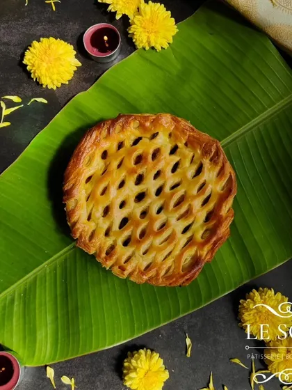 A top-down view of the Egg Roast Puff Pie, showing off its beautiful lattice crust. This 5-inch pie is perfect for sharing.