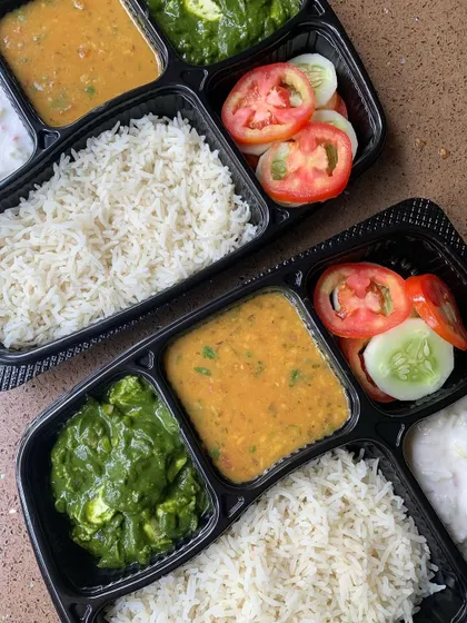 A close-up of my home-style meal plate, featuring Palak Paneer, Dal Tadka, rice, and salad. It's a nutritious and delicious option for your daily lunch.