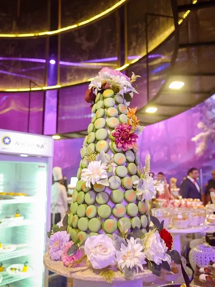 A stunning pistachio macaron tower, adorned with fresh flowers. These large-scale edible sculptures are a specialty of ours, creating a "wow" moment at any event.