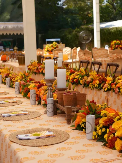 Long dining tables were decorated with runners of marigolds and other summer flowers, creating a continuous line of vibrant color.