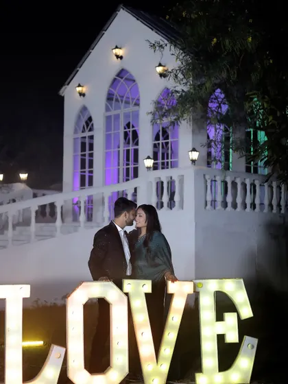 Another beautiful shot of our chapel and 'LOVE' prop, demonstrating how different poses can create varied looks in the same setting.