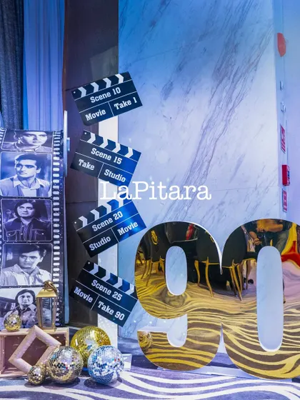 A decor piece celebrating '90', using a film reel motif and cascading movie clapperboards.
