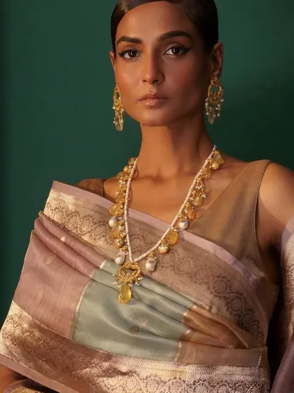 A surreal shot of a handwoven saree, where the focus is on the beautiful drape and the statement pearl and citrine necklace. This highlights my eye for pairing unique jewellery with heritage textiles.
