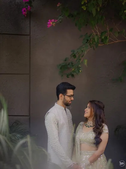 A quiet moment of connection shared between a couple amidst the greenery of their Mehendi venue. We look for peaceful spots to capture intimate portraits away from the crowd.